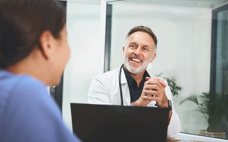 Arzt hinter Laptop im Gespräch – Symbolbild für Arbeitsmedizinische Fachsprechstunde